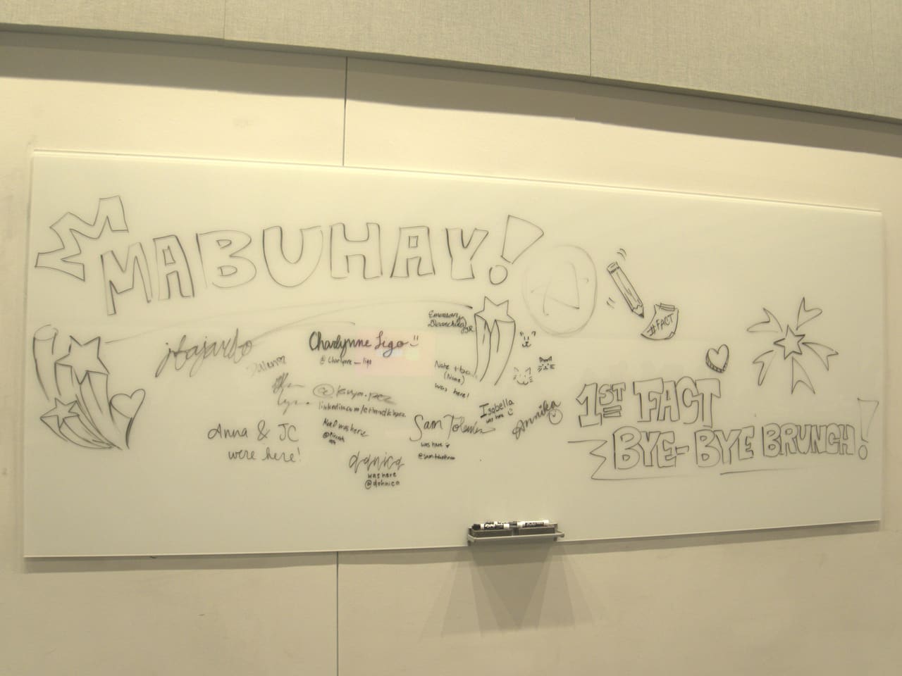 A whiteboard covered in farewell messages and drawings from delegates, reading &ldquo;Mabuhay!&rdquo;