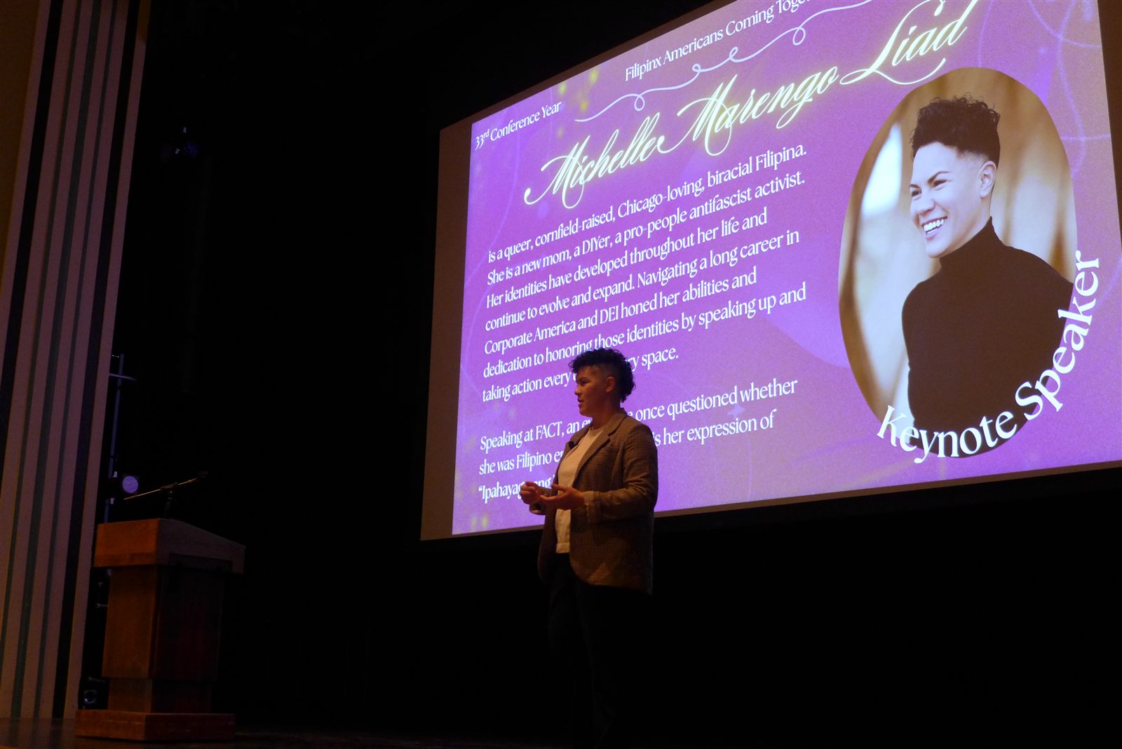 A keynote speaker presenting on stage at a past FACT conference